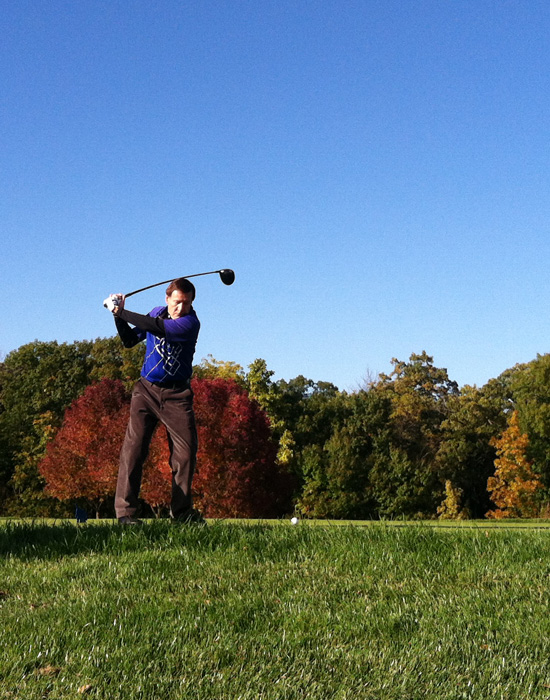 Les W. teeing off under a beautiful autumn sky.